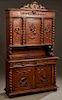 French Henri II Style Carved Oak Buffet a Deux Corps, c. 1880, the pierced lion and shield crest over a stepped crown above triple setback cupboard do