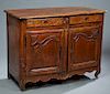 French Provincial Louis XV Style Carved Walnut Sideboard, early 19th c., the rounded edge and corner stepped three plank top over two frieze drawers a