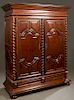French Louis XIII Style Carved Walnut Armoire, 19th c., the stepped ogee crown above double five panel doors with applied geometric carving, flanked b