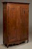 Southern Louisiana Creole Carved Walnut Armoire, 18th c. and later, the curved corner stepped crown over double inset panel doors with short iron fich