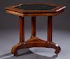 American Carved Walnut Hexagonal Center Table, 19th c., the inset black marble top within a wide border, on three tapered fluted supports to a tripoda