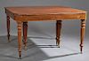 English William IV Carved Mahogany Dining Table, c. 1850, the reeded edge rounded corner top over a wide skirt, on turned reeded tapered legs on caste