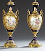 Exceptional Pair of Bronze Ormolu Mounted Cobalt Sevres Porcelain Vases, early 20th c., the sides with gilt bronze ring handles and elaborate applied 