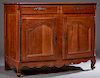 French Louis XV Style Cherry Sideboard, c. 1770, the stepped rounded edge top over two frieze drawers with compartmentalized interiors with steel escu