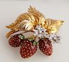Unusual 18K Yellow Gold, Diamond and Enamel Strawberry Brooch, 20th c., Italy, with three large leaves atop two round diamond flowers with round 15 po