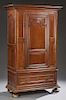 Louis XVI Style Carved Cherry Armoire, 19th c., the stepped crown over an arched fielded panel door, flanked by inset panels, above a single long draw
