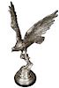 Large Silver Patinated Bronze Spread Wing Eagle, 20th c., landing on a branch, on an integral relief base, on a circular black marble plinth, H.- 36 1
