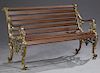Brass Plated Iron Park Bench, 20th c., the slatted back and seat, enclosed by scrolled arms on lions head supports to scrolled legs, H.- 31 in., W.- 5