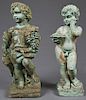 Pair of Cast Stone Figures of Putti, 20th c., representing two of the four seasons, on integral plinth bases, now in green paint, H.- 29 in., W.- 9 1/