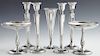 Seven Pieces of Sterling, 20th c., consisting of four weighted candlesticks, by Revere; a pair of weighted footed compotes, by Wallace; and a bud vase