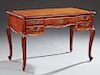 French Louis XV Style Carved Cherry and Beech Desk, 20th c., the stepped rounded edge and corner top with an inset gilt tooled salmon colored leather 