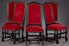Set of Six French Louis XIII Style Carved Walnut Upholstered Highback Dining Chairs, 20th c., the arched backs over trapezoidal seats on scrolled cabr