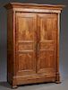 French Louis Philippe Style Carved Walnut Armoire, c. 1880, the stepped ogee crown above two set back triple panel doors flanked by ormolu mounted tap