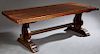 French Carved Oak Monastery Table, 19th c., the thick hand hewn top, on thick pierced trestle bases on stepped splayed plinths, H.- 30 1/2 in., W.- 86