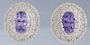 Pair of 14K White Gold Pierced Earrings, each with a 2.71 carat oval tanzanite atop a border of small round diamonds and a pierced border with round d