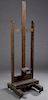 French Carved Oak Adjustable Artist's Easel, 19th c., on a splayed leg base joined by a stretcher, on wooden wheels, H.- 71 in., W.- 21 3/8 in., D.- 2