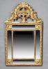 French Louis XVI Style Gilt and Gesso Overmantle Mirror, 19th c., with a pierced shell and floral basket scrolled crest over a relief scrolled frame e
