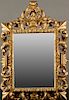 French Louis XV Style Gilt and Gesso Overmantle Mirror, 19th c., the pierced scrolled curved crest over a frame of large relief pierced scrolls, with 