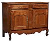 French Louis XV Style Carved Cherry Buffet a Deux Corps, 19th c., the arched stepped canted corner crown over double arched cupboard doors with brass 