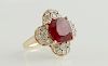 Lady's 14K Rose Gold Dinner Ring, with a cushion cut 6.68 carat ruby atop a stylized floret mounted with round diamonds, total diamond weight- .99 cts