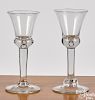 Two blown colorless glass teardrop wine glasses