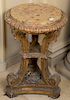 Baroque style gilt stand with round marble top over triple supports on three sided base, 19th century. 
height 30 inches, diameter 2...