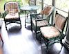 Seven pieces of antique Bar Harbor wicker to include chaise, three armchairs, one tall round table, low round side table, and one si...