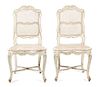 A Pair of Louis XV Style Carved and Painted Caned Back and Seat Side Chairs Height 38 1/2 inches.