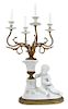 A Continental Bisque Mounted Gilt Bronze Four-Light Candelabrum Height to bulb 29 x width 14 x depth 14 inches.