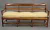 Continental fruitwood bench with rush seat and custom cushion. ht. 36 in., wd. 77 in.
