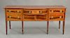 Federal mahogany sideboard, drawers and doors flanked by doors, circa 1800. ht. 34 in., wd. 77in.