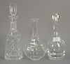 Three crystal decanters, Lalique, Steuben with stopper, and a Waterford with stopper. ht. 9 1/2in., 11in. & 13in.