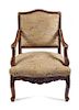 A Regence Walnut Fauteuil Height 37 inches.