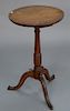 Cherry candle stand having round top on turned shaft set on unusual carved tripod base. 
height 27 in., top: 16 1/4" x 16 1/2"