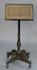 Duet music stand with caned top having original stenciling and embossed brass (top wobbly), 19th century.  height 44 in., width 19...