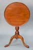 Mahogany dish top tip table on turned shaft set on tripod base. 
height 27 in., diameter 21" x 20 5/8"