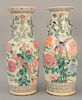 Two large Chinese porcelain famille rose baluster vases, both having foo dog handles and painted with blossoming flowers and birds. ...