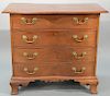Mahogany diminutive oxbow chest having overhanging top over four conforming drawers on skirt with carved center and ogee feet. heigh...