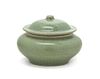 A Chinese Celadon Glazed Pottery Jar and Cover Height 3 1/4 inches.