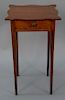 Federal cherry one drawer stand having shaped top set on square tapered legs, circa 1800. 
height 27 1/2 in., top: 16 1/8" x 16 1/4"