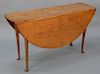 Cherry Queen Anne drop leaf table on turned legs set on pad feet. 
height 26 in., top closed: 13 1/2" x 48", top open: 47 1/2" x 48"