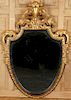 CARVED GILT WOOD SHIELD SHAPED MIRROR BY DAUPHINE