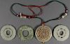 FOUR CHINESE CARVED JADE DISC FORM PENDANTS QING