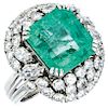 An emerald and diamond platinum ring.