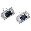A pair of sapphire and diamond 14K white gold earrings.