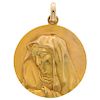 An 18K yellow gold religious medal.