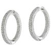 A pair of diamond 14K white gold hoop earrings.