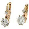 A pair of diamond 14K yellow gold earrings.
