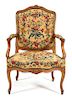 A Louis XV Style Carved Fruitwood Fauteuil Height 38 3/4 inches.