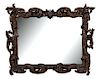 A English Carved and Ebonized Mirror Frame Height 60 x width 70 inches.